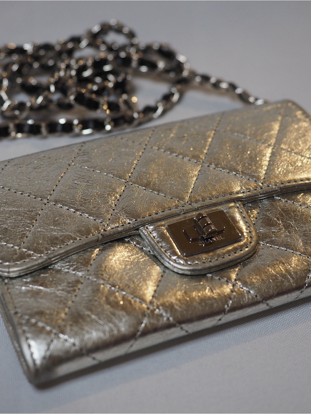 CHANEL Metallic Reissue-style wallet with aftermarket chain